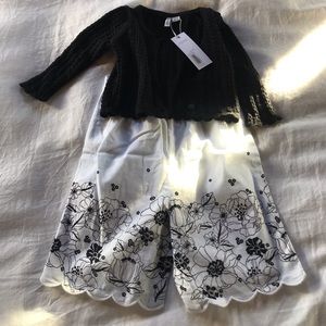 White and black romper with black sweater